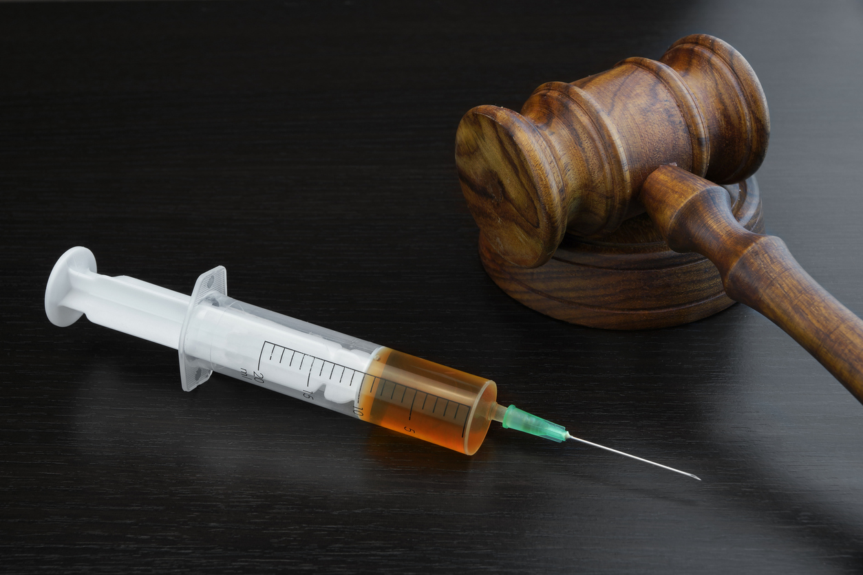 Judges Gavel And Medical Injection Syringe