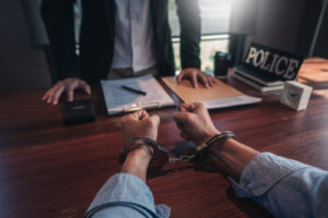 a police interrogating a suspect representing the article's topic about Do I Need a Criminal Defense Lawyer if I’m Innocent?