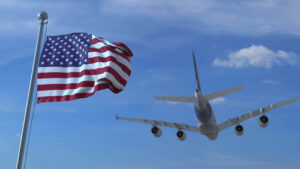 airplane landing behind waving American flag representing the article about Immigration Consequences of a Criminal Conviction