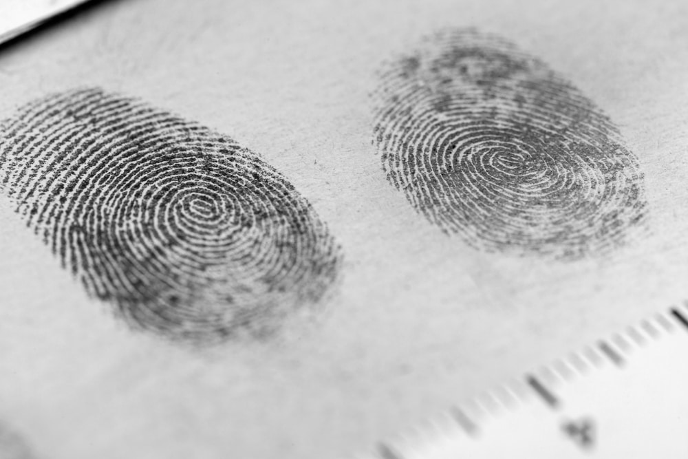 Fingerprints on a piece of paper representing the article’s topic about reducing a felony to a misdemeanor in Los Angeles.