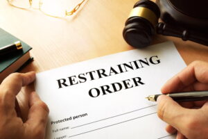 a picture of someone signing a restraining order representing the article's topic about How to Get a Restraining Order Against a Minor