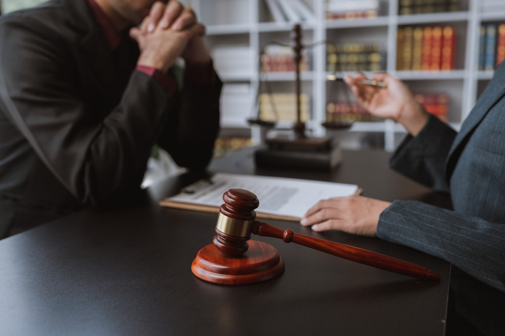 lawyer and client discussing the case's progress to represent the article about What Does “Status Conference” Mean in a California Criminal Case?