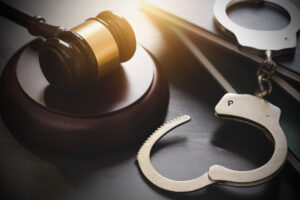 open handcuffs and a gavel illustrating the article "What Does Unsupervised Probation Mean?"