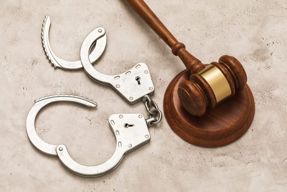 a gavel and open handcuffs representing the article about What is Diversion and Intervention in Lieu of Conviction?