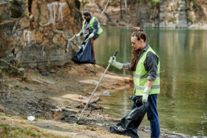 Criminal cleaning lakeshore as part of community service representing the article about What is Diversion and What Is Criminal Trespass?