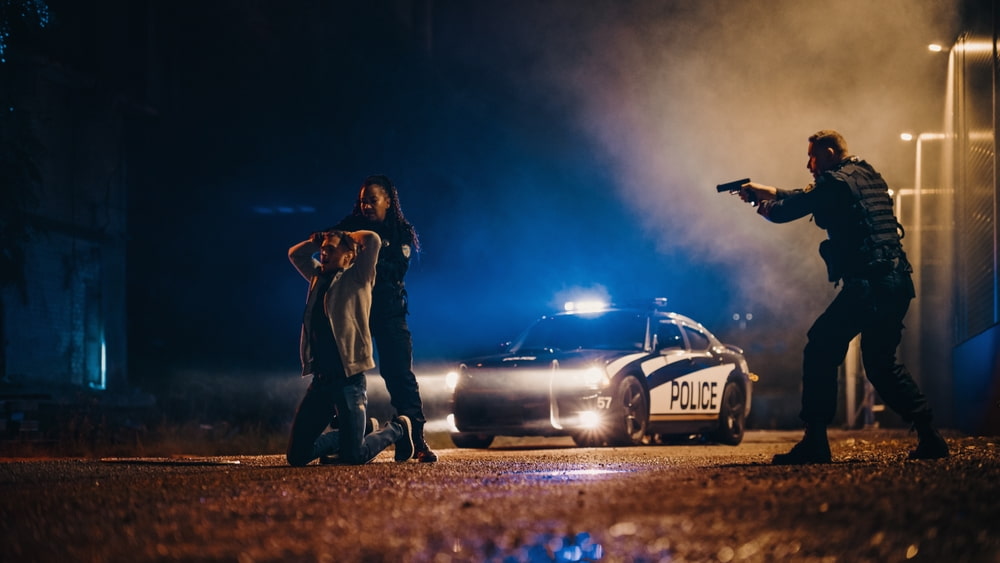 two police officer arresting a suspect representing the article What is Probable Cause?