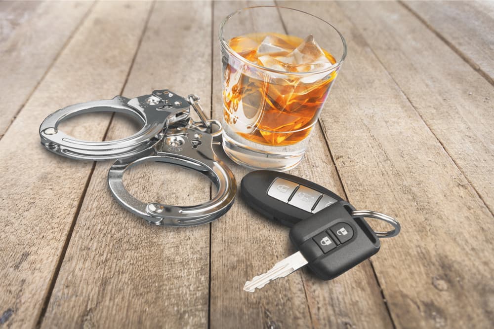 Alcohol with car keys and handcuffs