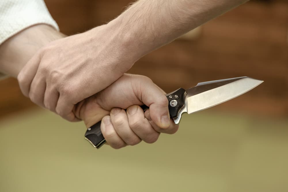 Self defense disarming technique against threat and knife attack