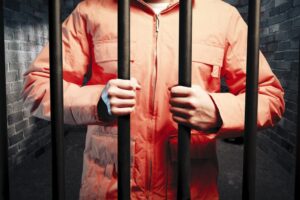 A man in dark prison cell at night