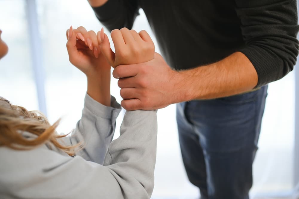 Man beating up his wife illustrating domestic violence.